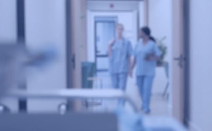 Two nurses in a clinical setting, blurred